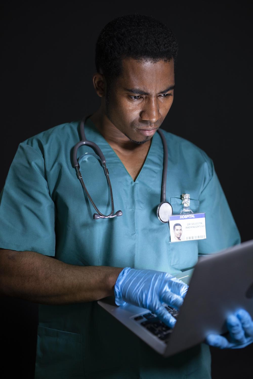 HIPAA Consulting Group doctor with a laptop